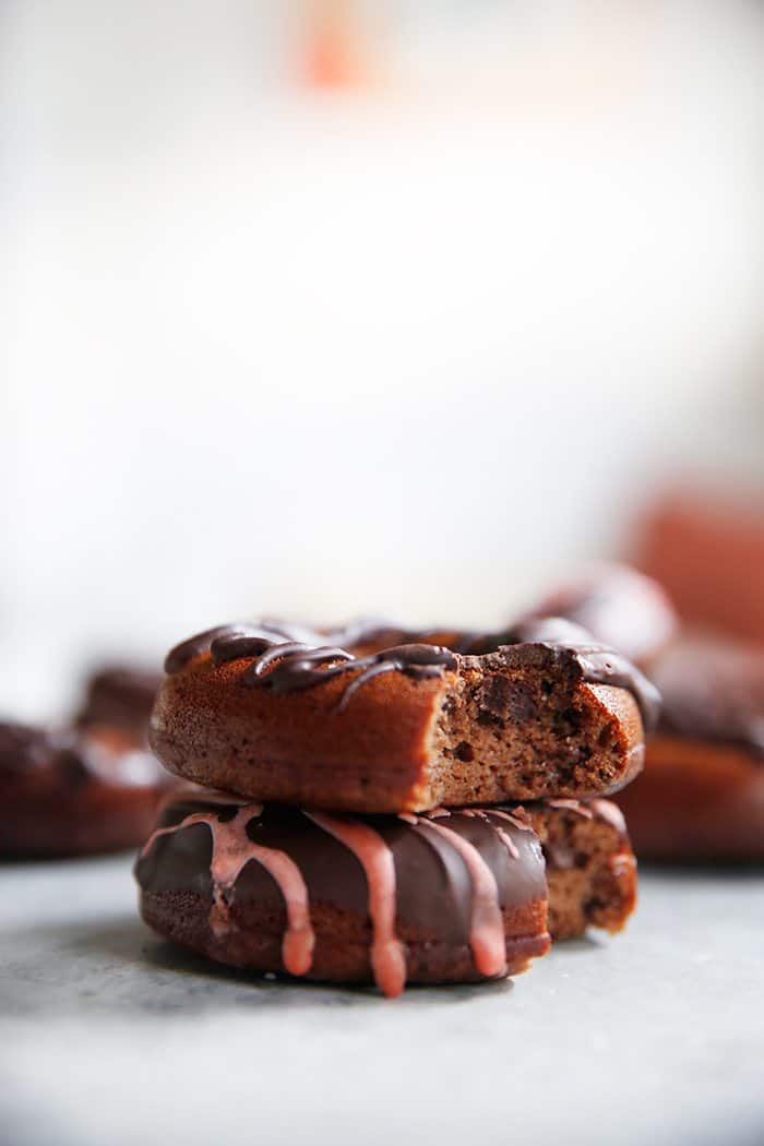 side view of two chocolate donuts stacked