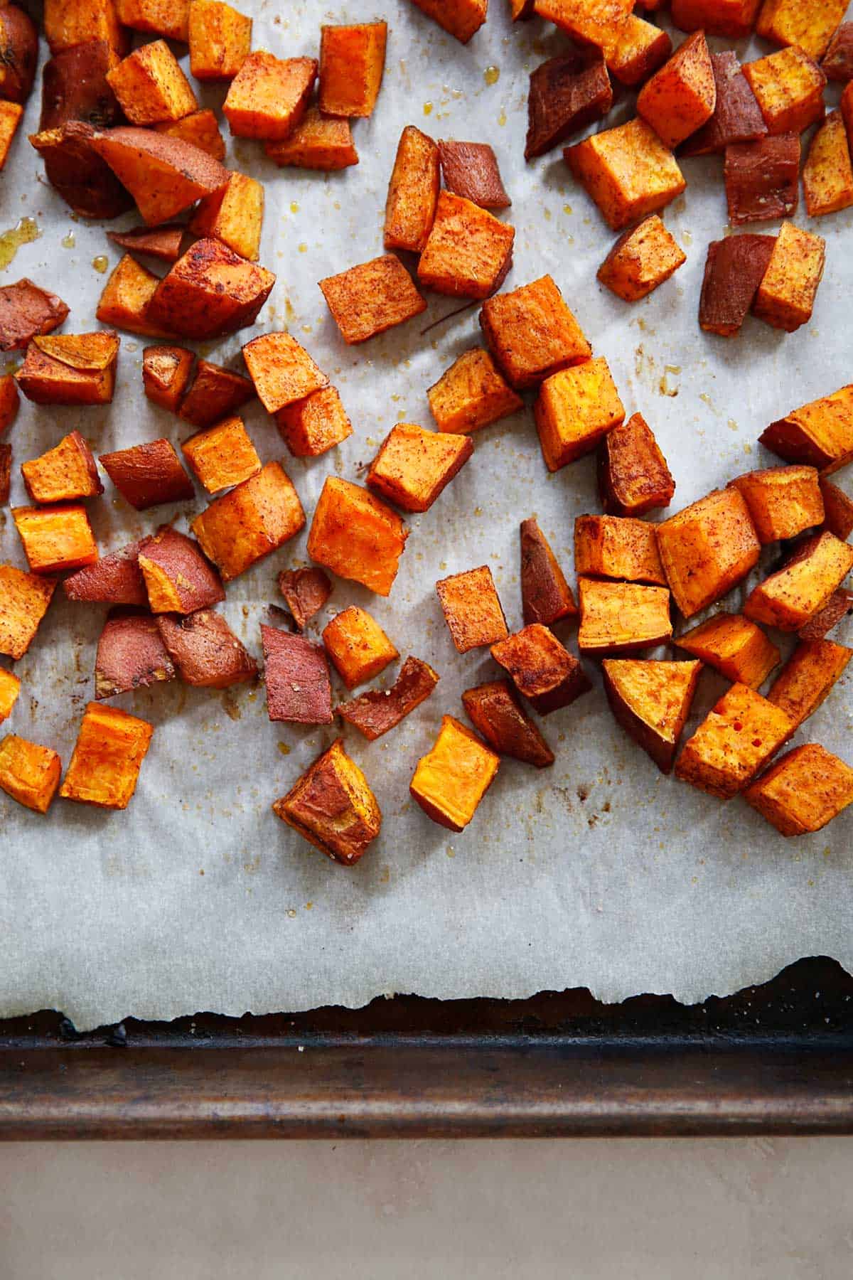 roasted cinnamon sweet potatoes on a sheet pan
