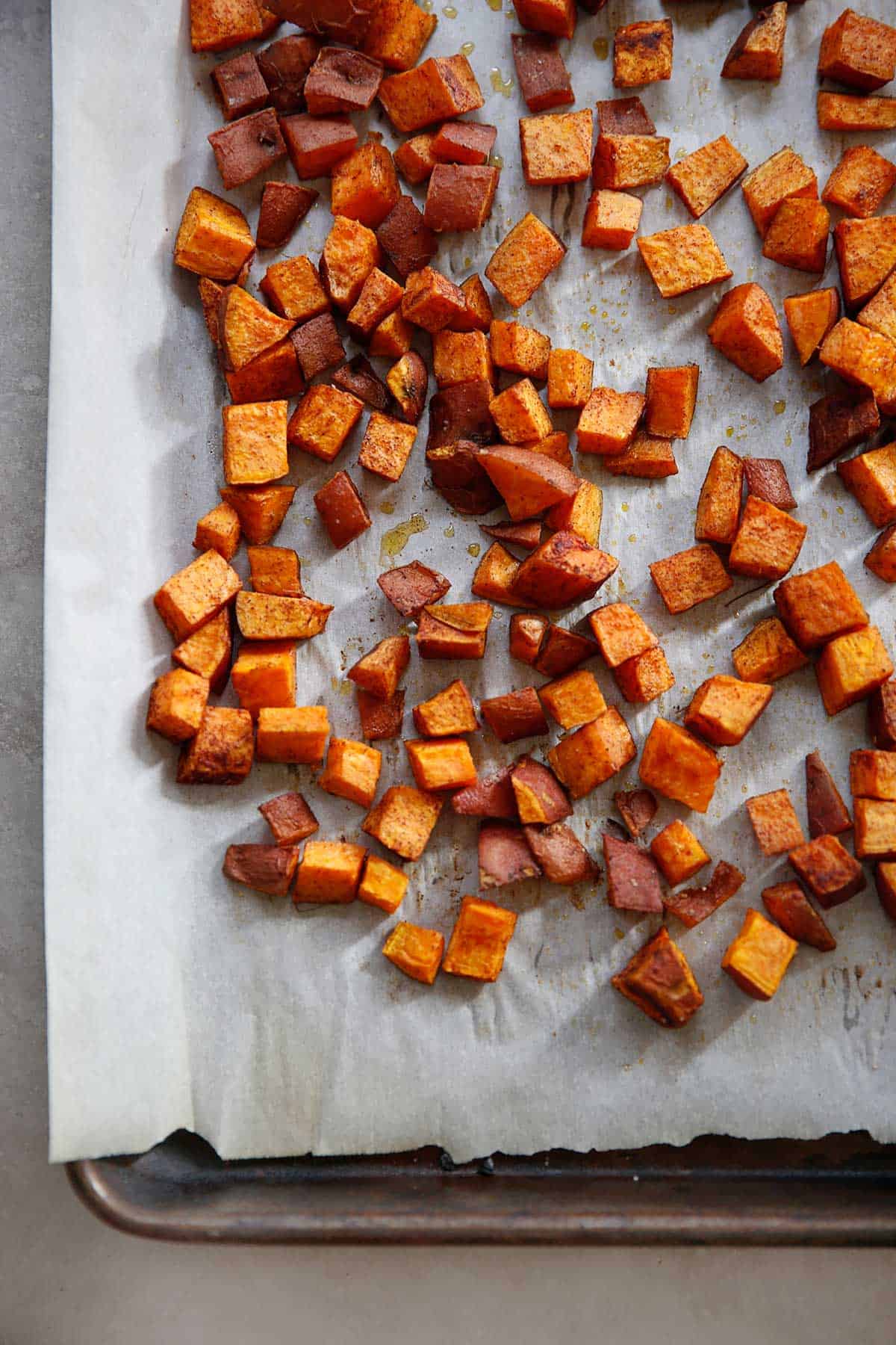 sweet potatoes cubed on a sweet pan ready to eat