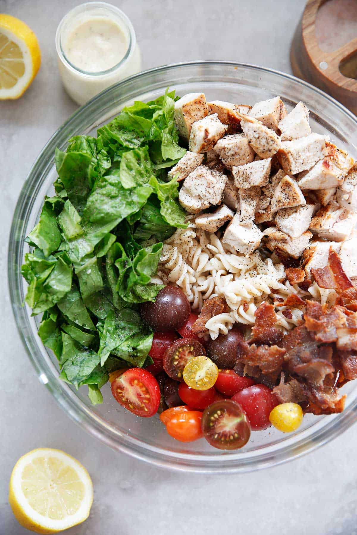 overhead of pasta salad ingredients unmixed in a bowl.