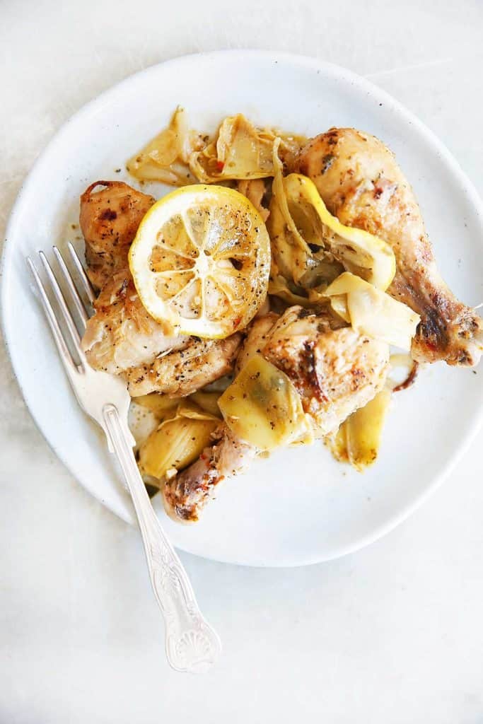 a plate filled with lemon roasted chicken.