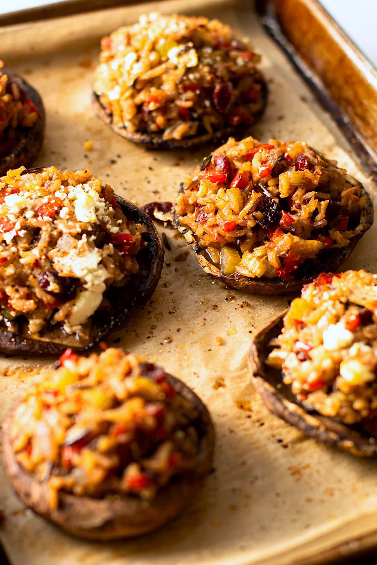 Vegetarian stuffed mushrooms on a baking sheet.