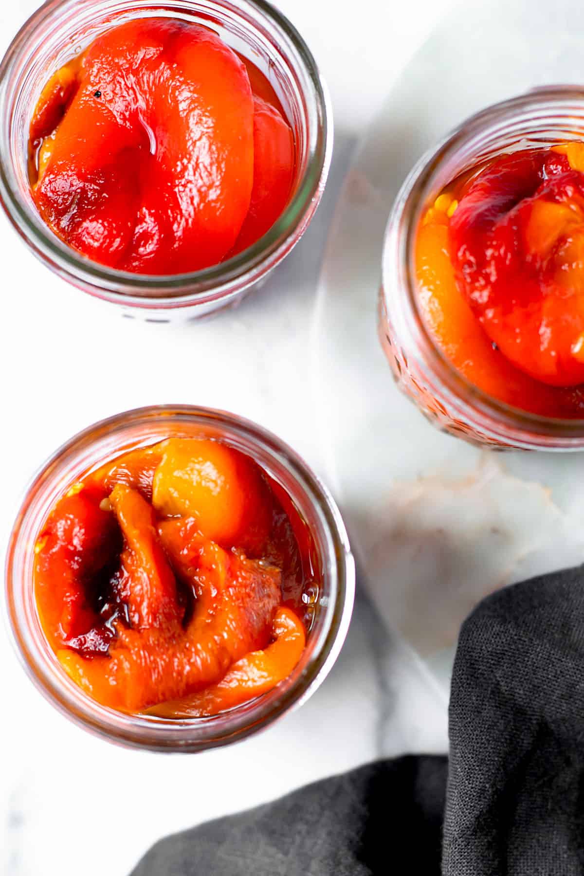 Roasted red peppers in three jars overhead.