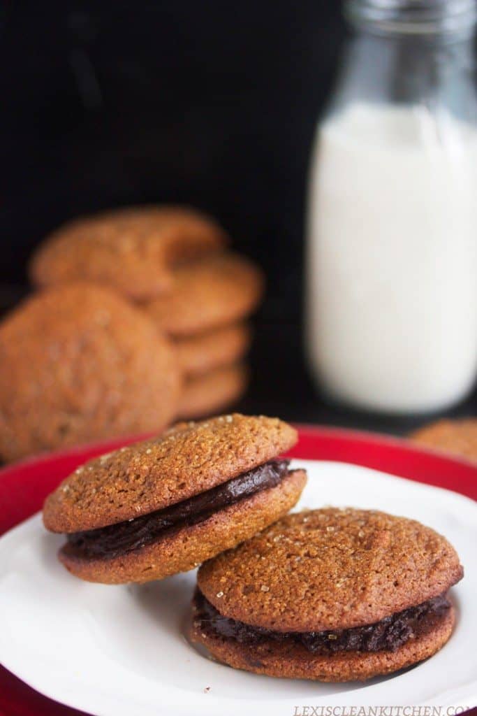 Photo shows two molasses cookies with fudge between them