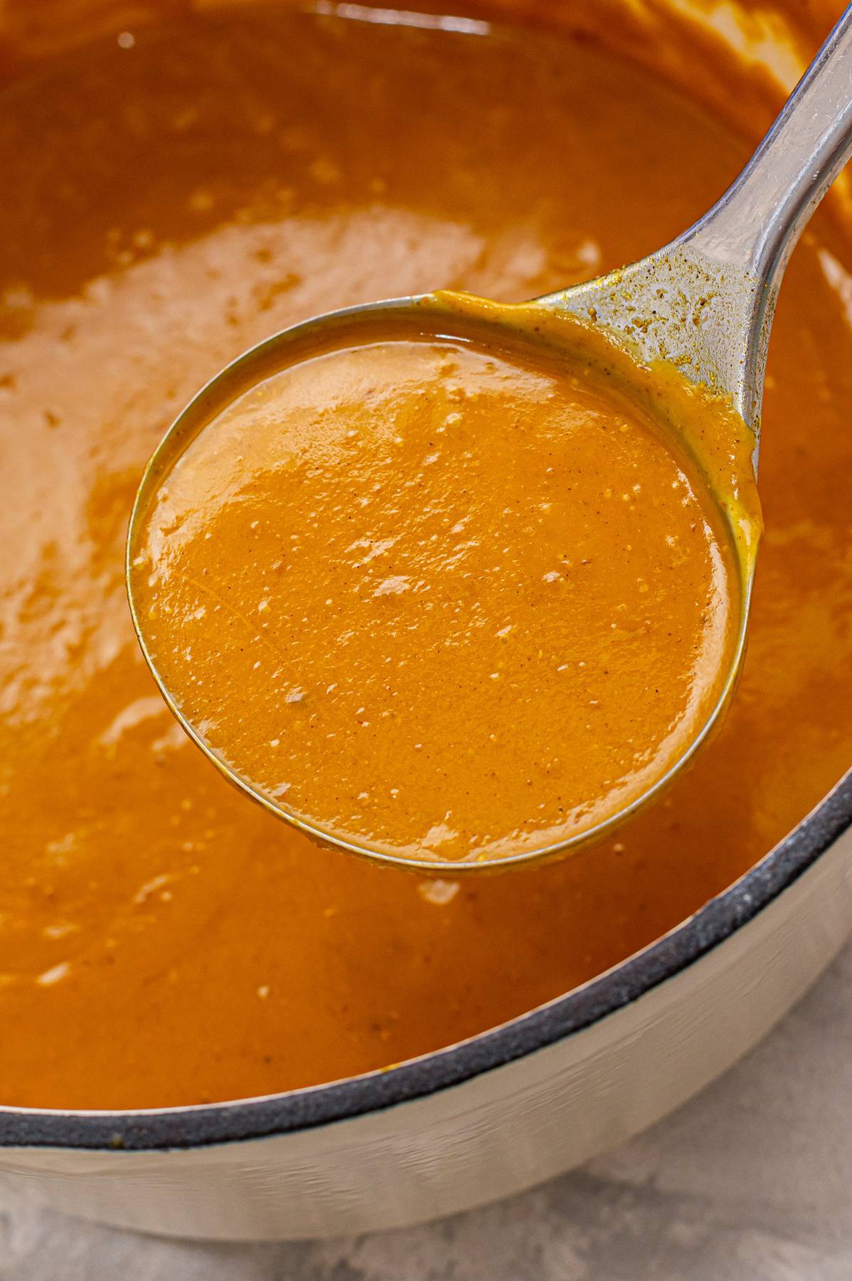 A ladle full of butternut squash soup