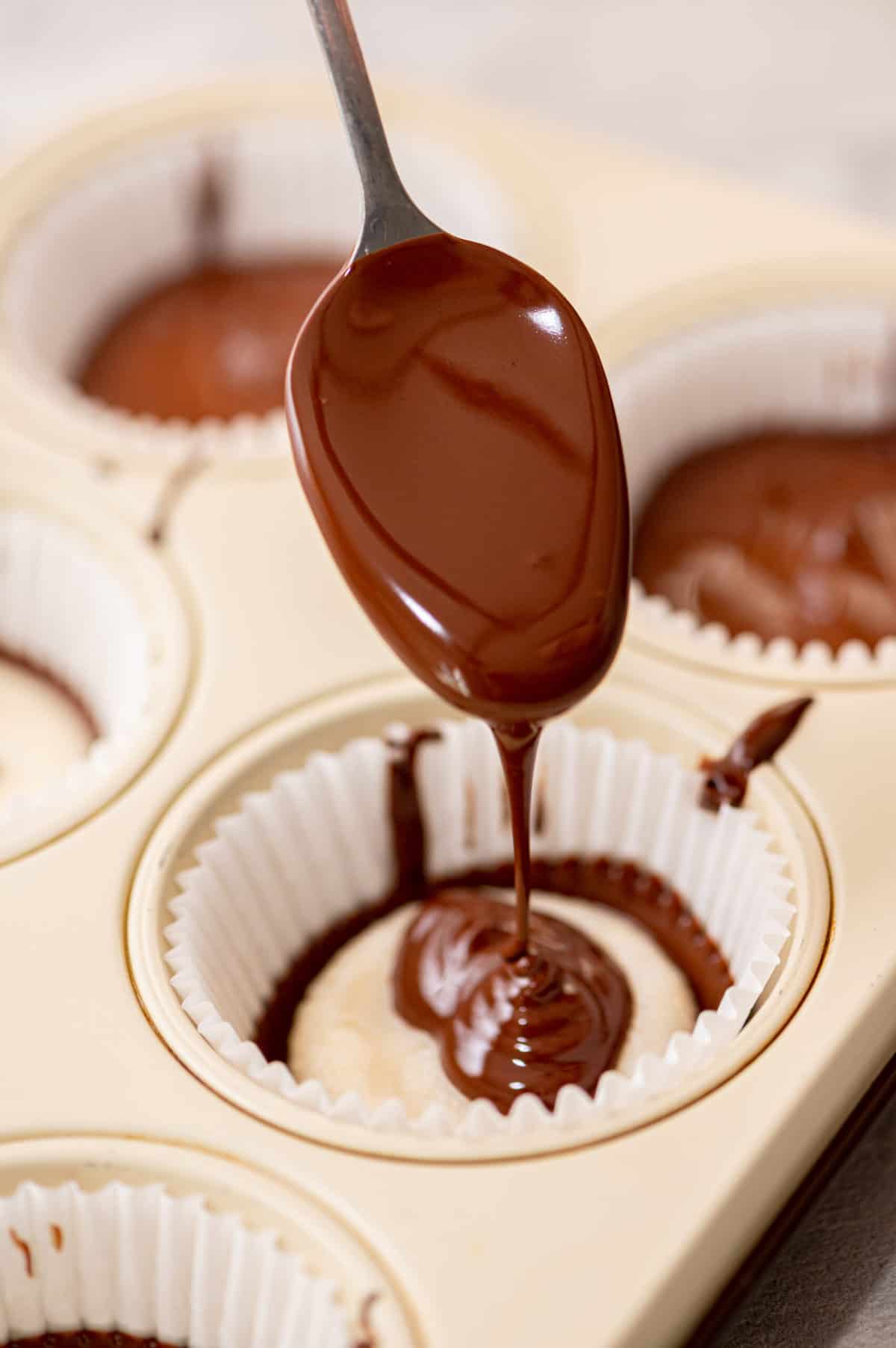 Drizzling chocolate to make coconut butter cups.