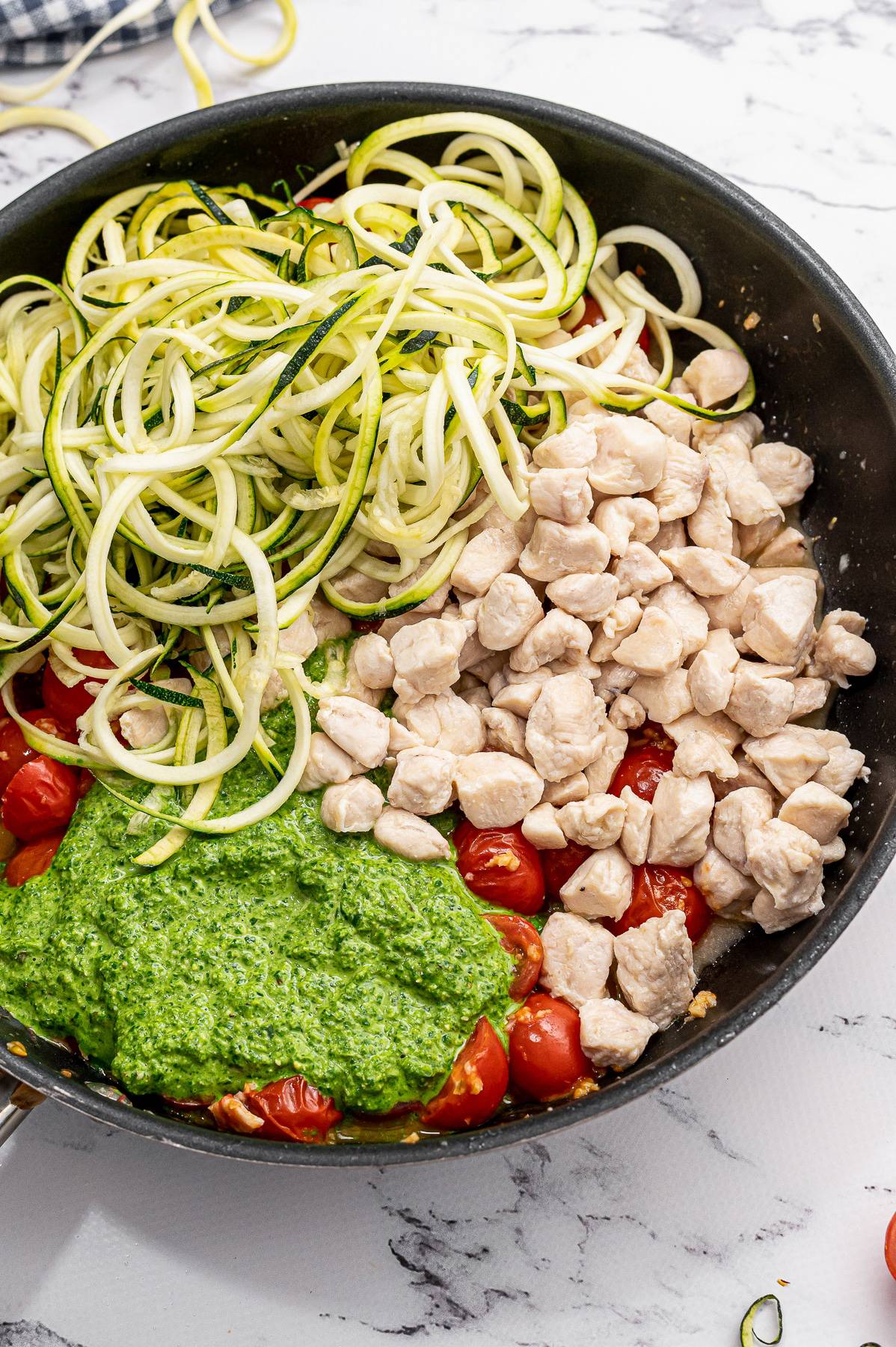 pesto noodle ingredients in a pan.