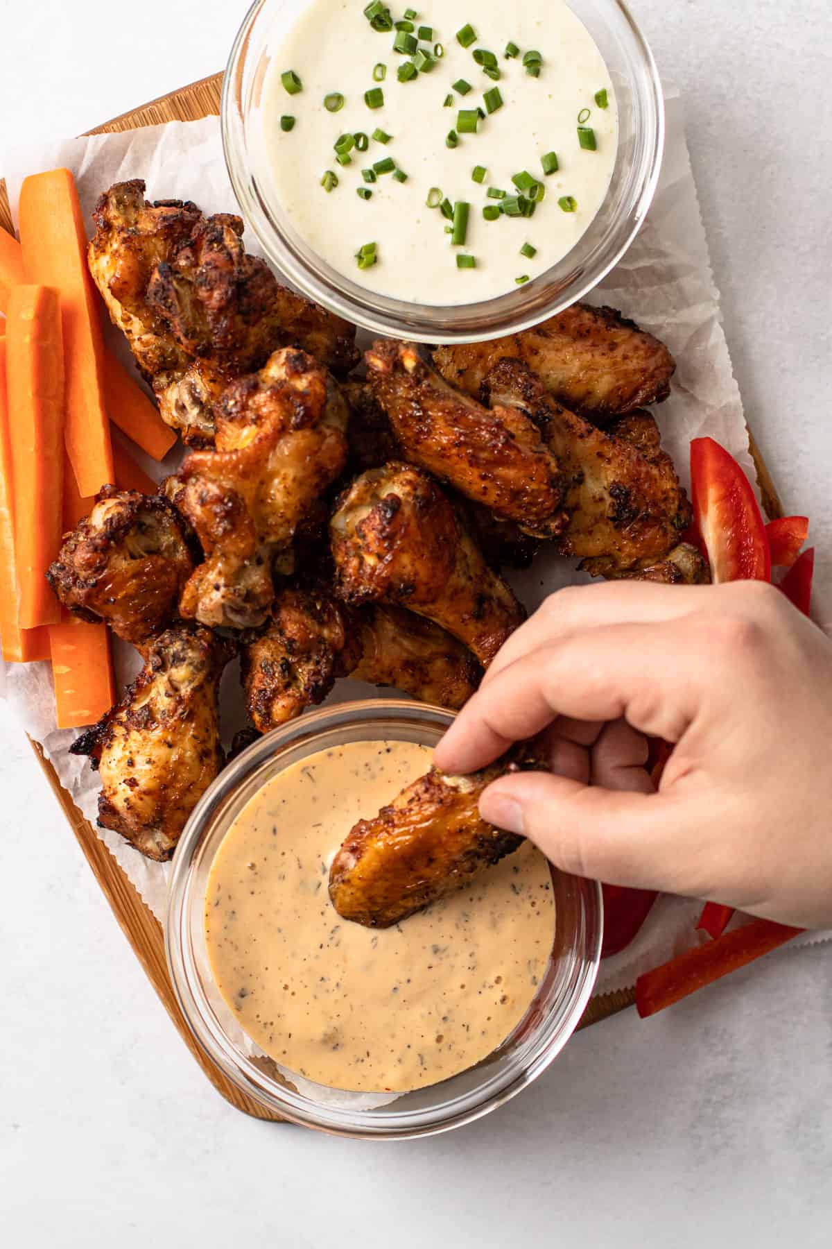 Air fryer chicken wings with dipping sauce.