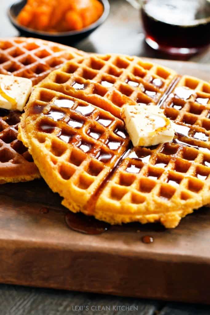 Almond Flour Pumpkin Waffles topped with butter and syrup. 