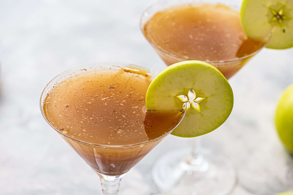 Caramel Apple Martini with an apple slice on the rim.