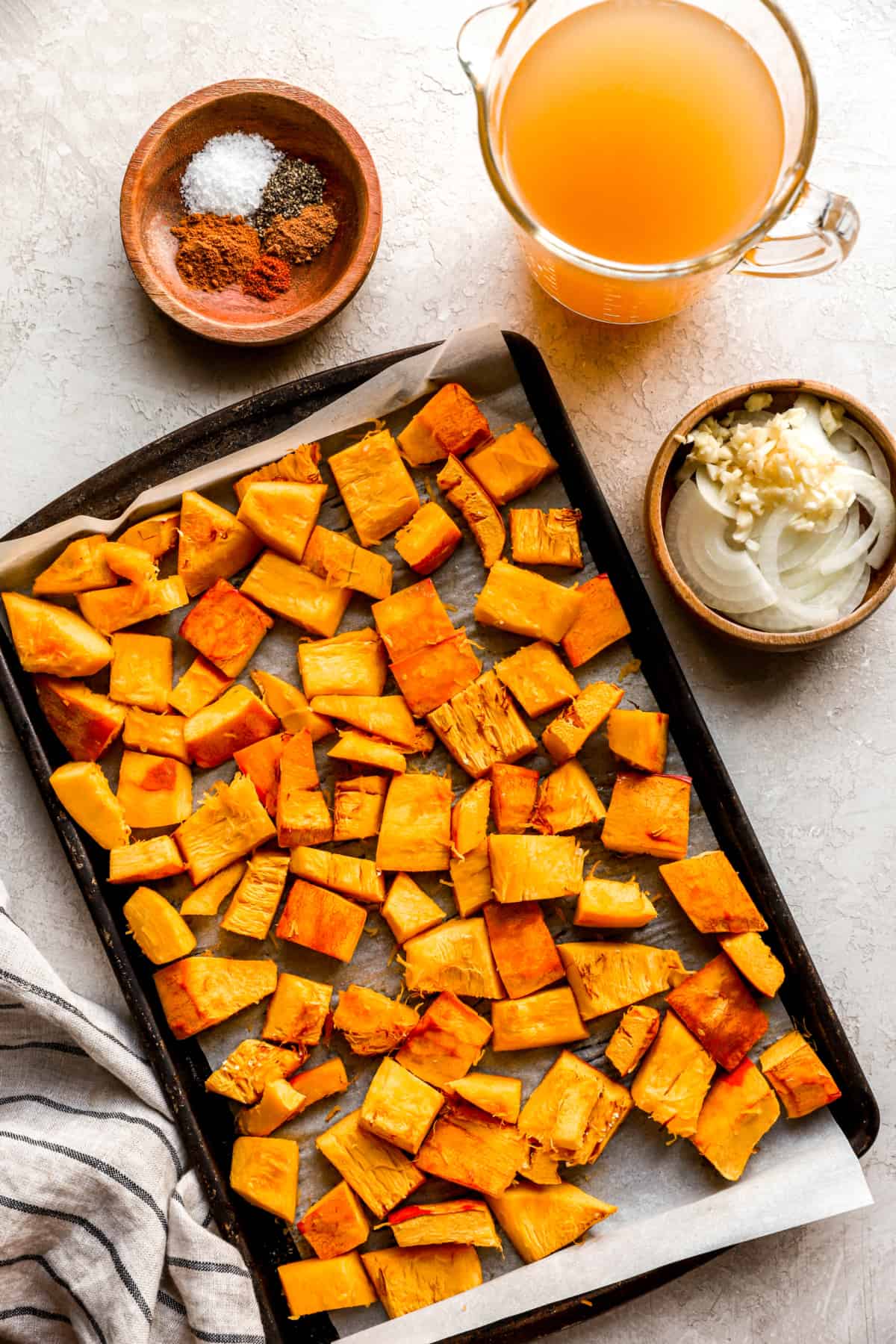 roasted pumpkin cubes on a baking sheet from above.
