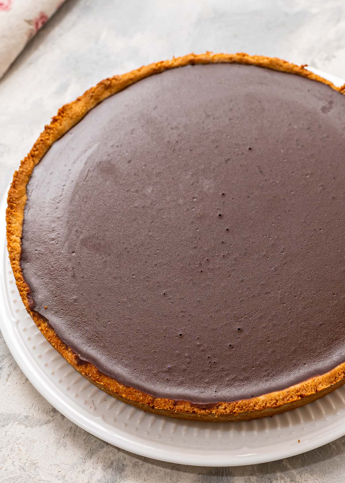 A gluten-free chocolate tart on a plate.