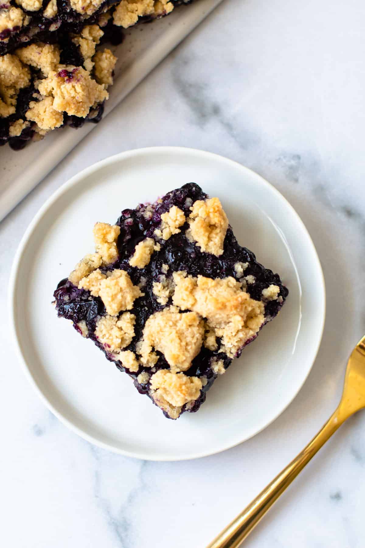 A healthy blueberry bar slice on a plate.