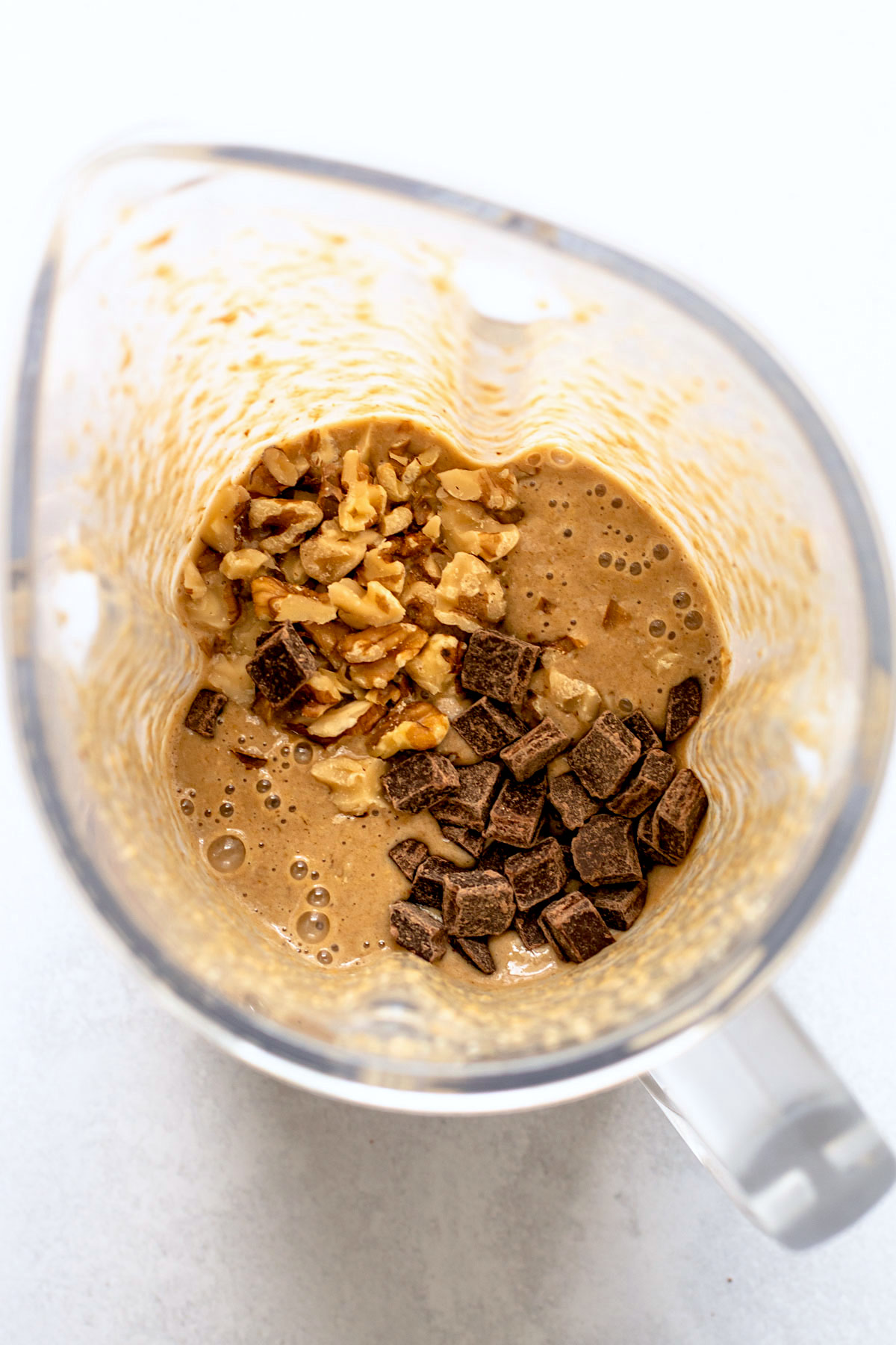 Chunky monkey ingredients added into the oat batter in a blender.