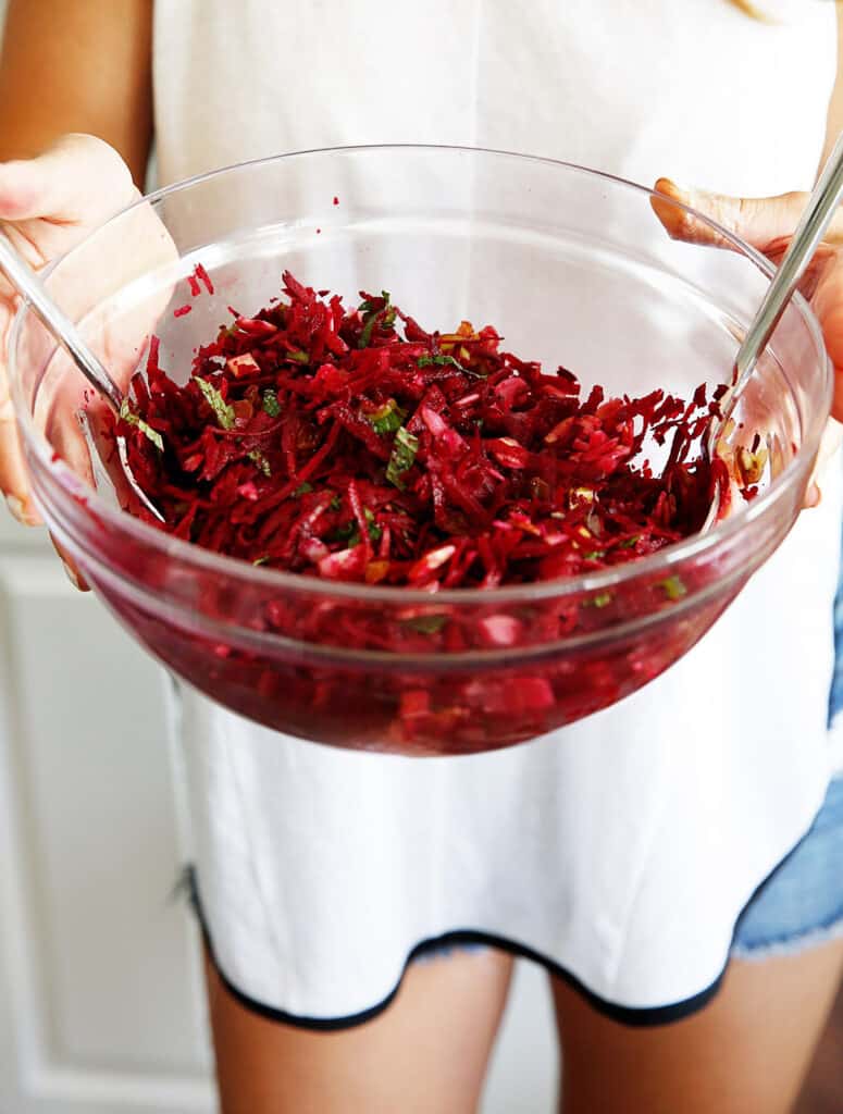 A bowl of beet slaw with ginger and mint.