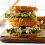 Cranberry Walnut Chicken Salad sandwiches stacked on top of one another.
