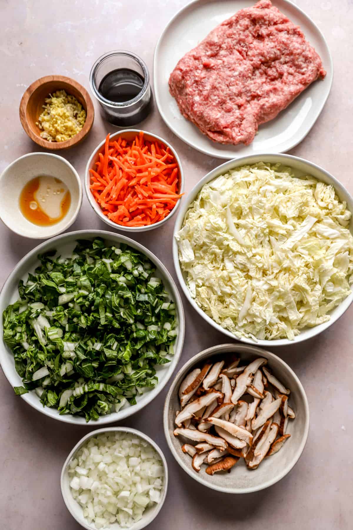 egg roll bowl ingredients in separate dishes from above.