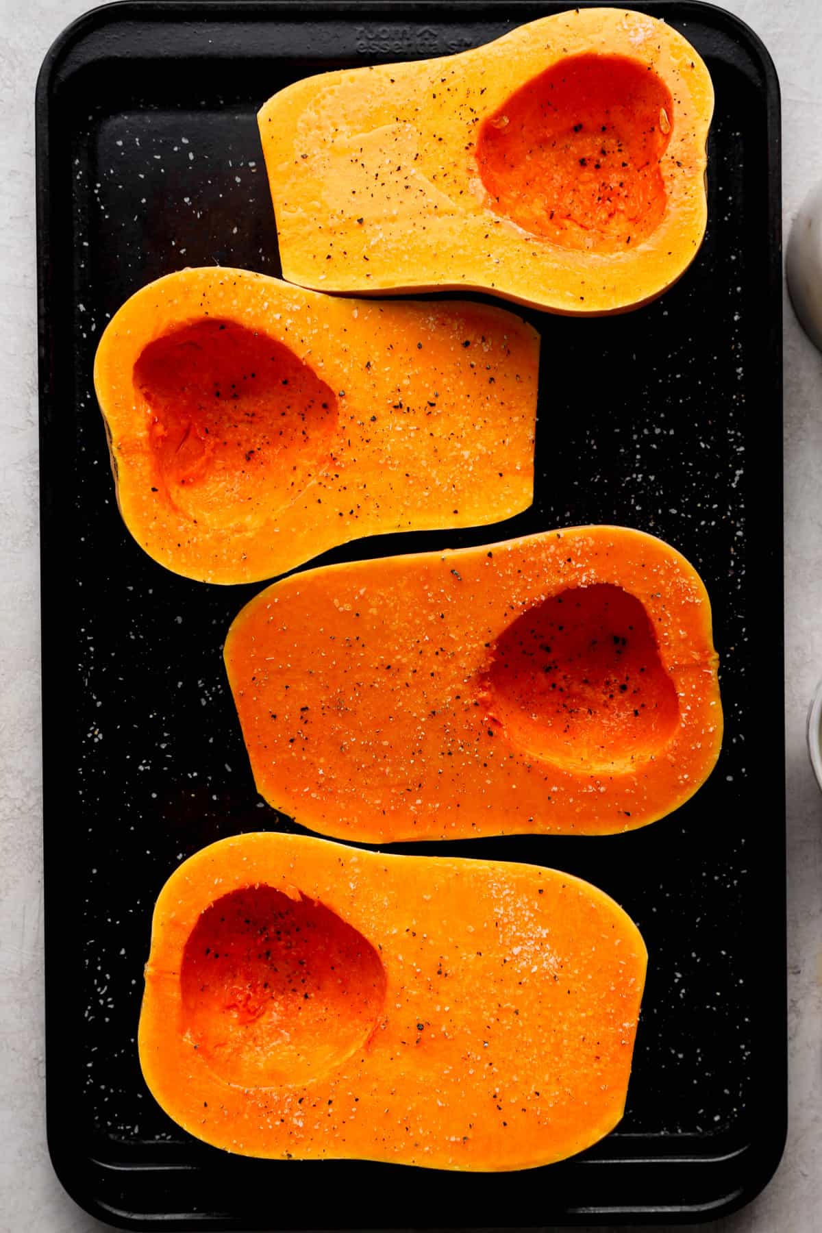 four halves of a butternut squash from above.