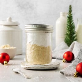 a mason jar filled with pancake mix surrounded by holiday decorations.