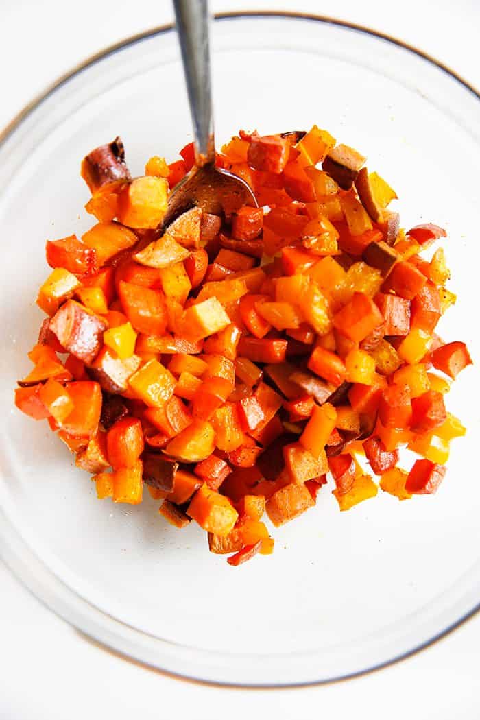 A bowl of orange roasted vegetables.