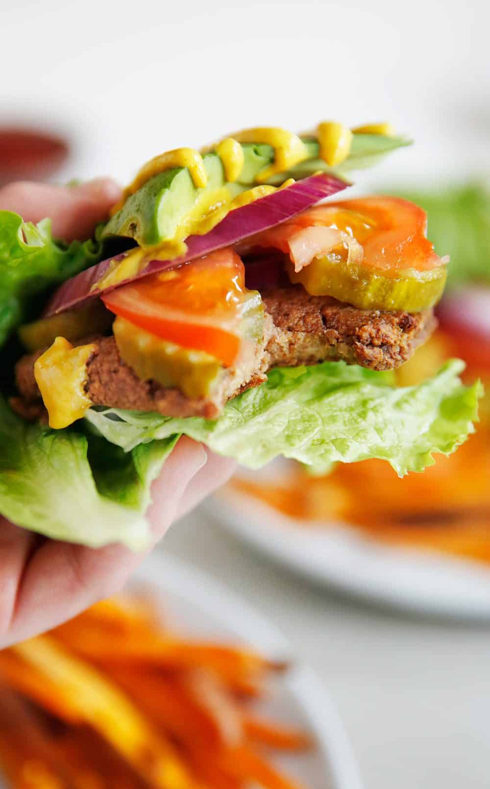 Meatless Mushroom Burgers in a lettuce wrap with burger toppings.