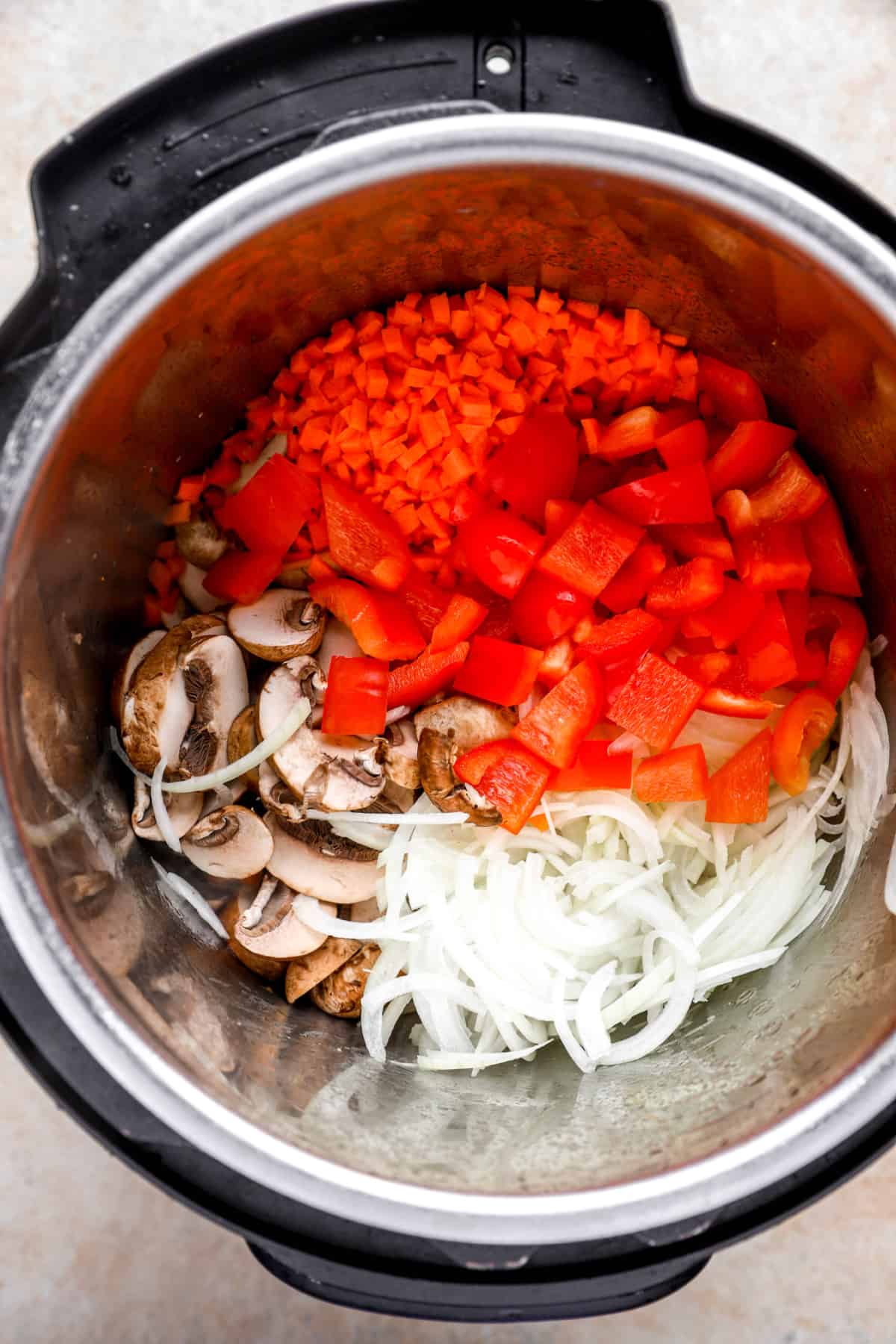 pepper, carrot, mushroom, and onion in an instant pot from above.