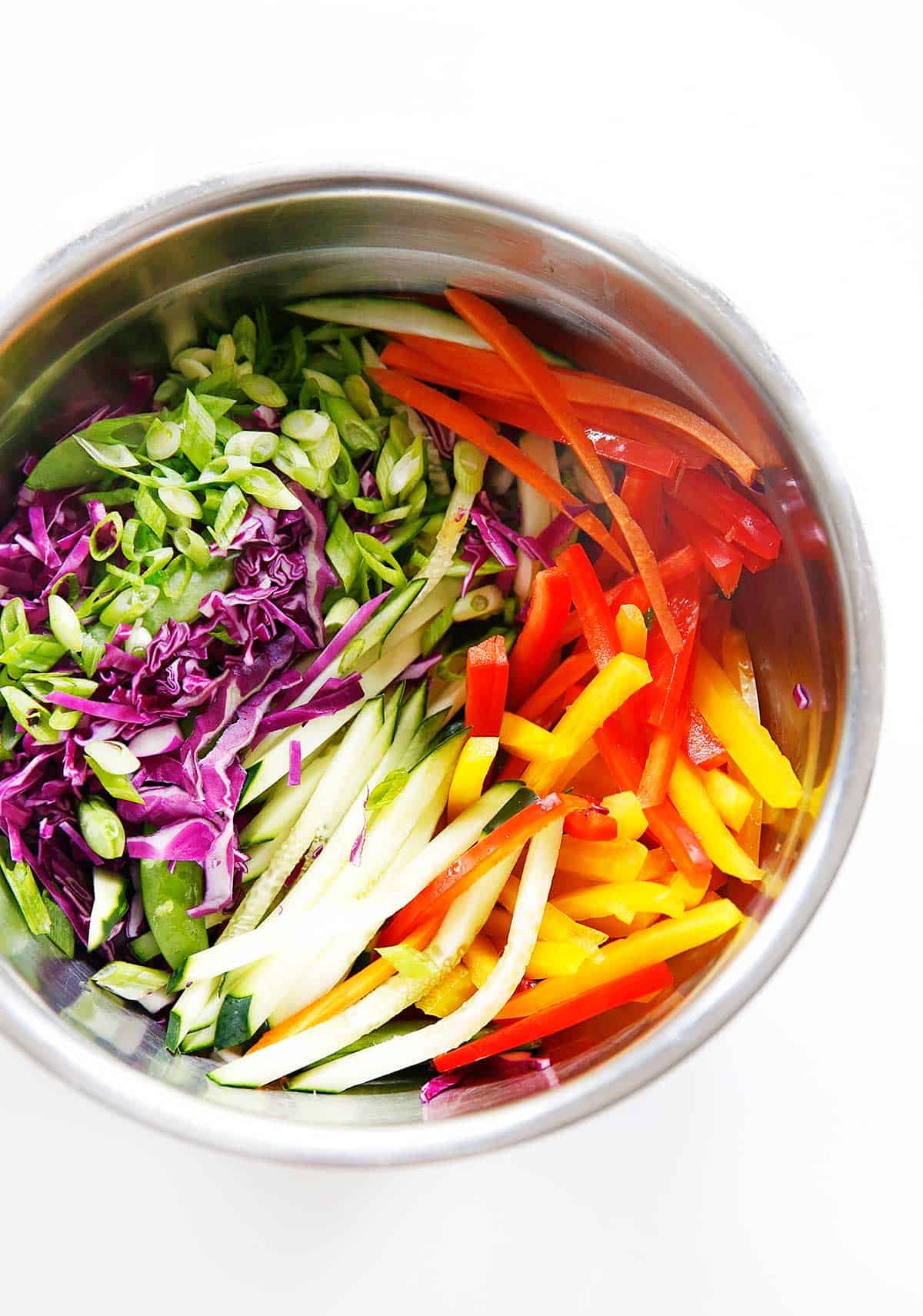 fresh veggies in a mixing. bowl overhead.