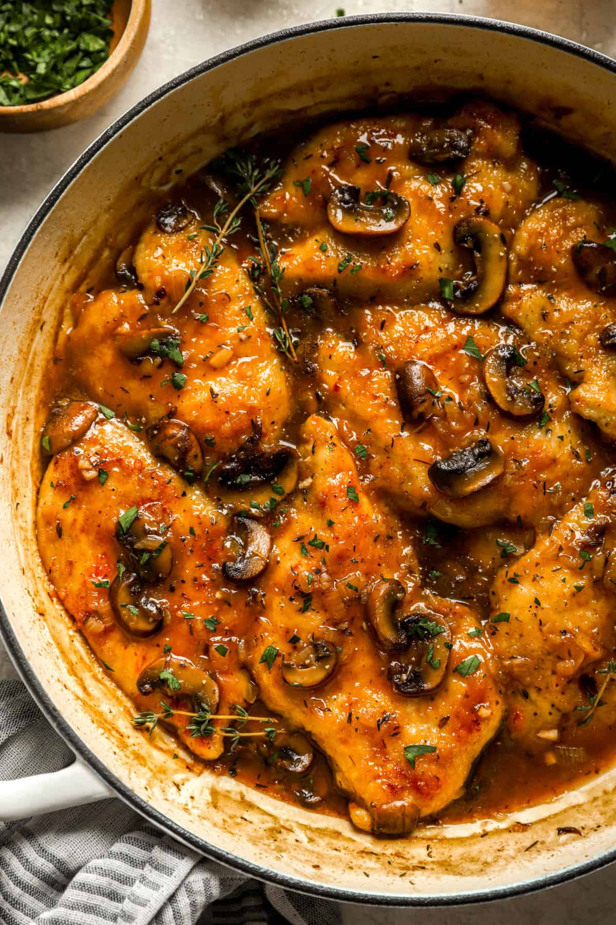 above image of chicken marsala in a skillet with mushrooms.