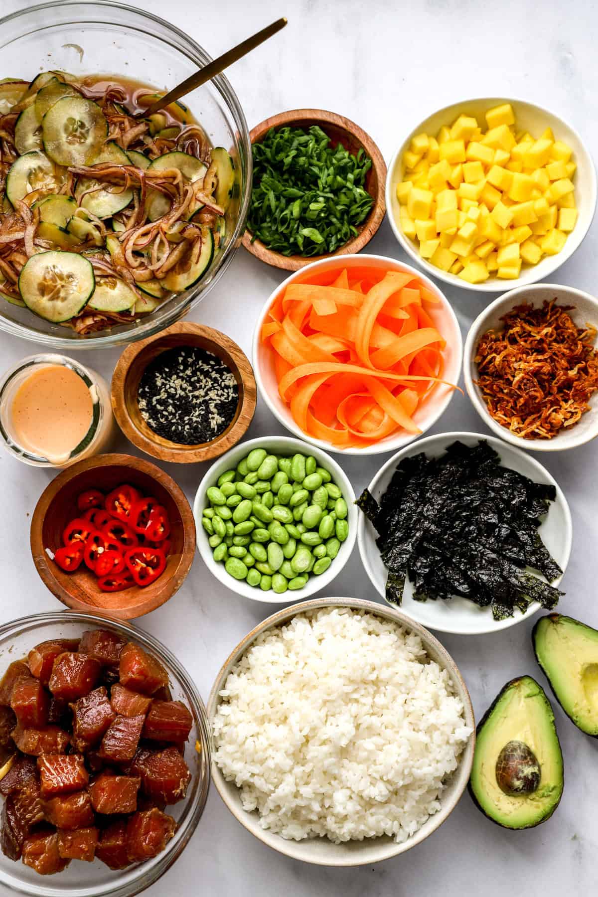 all poke bowl ingredients in bowls from above. 