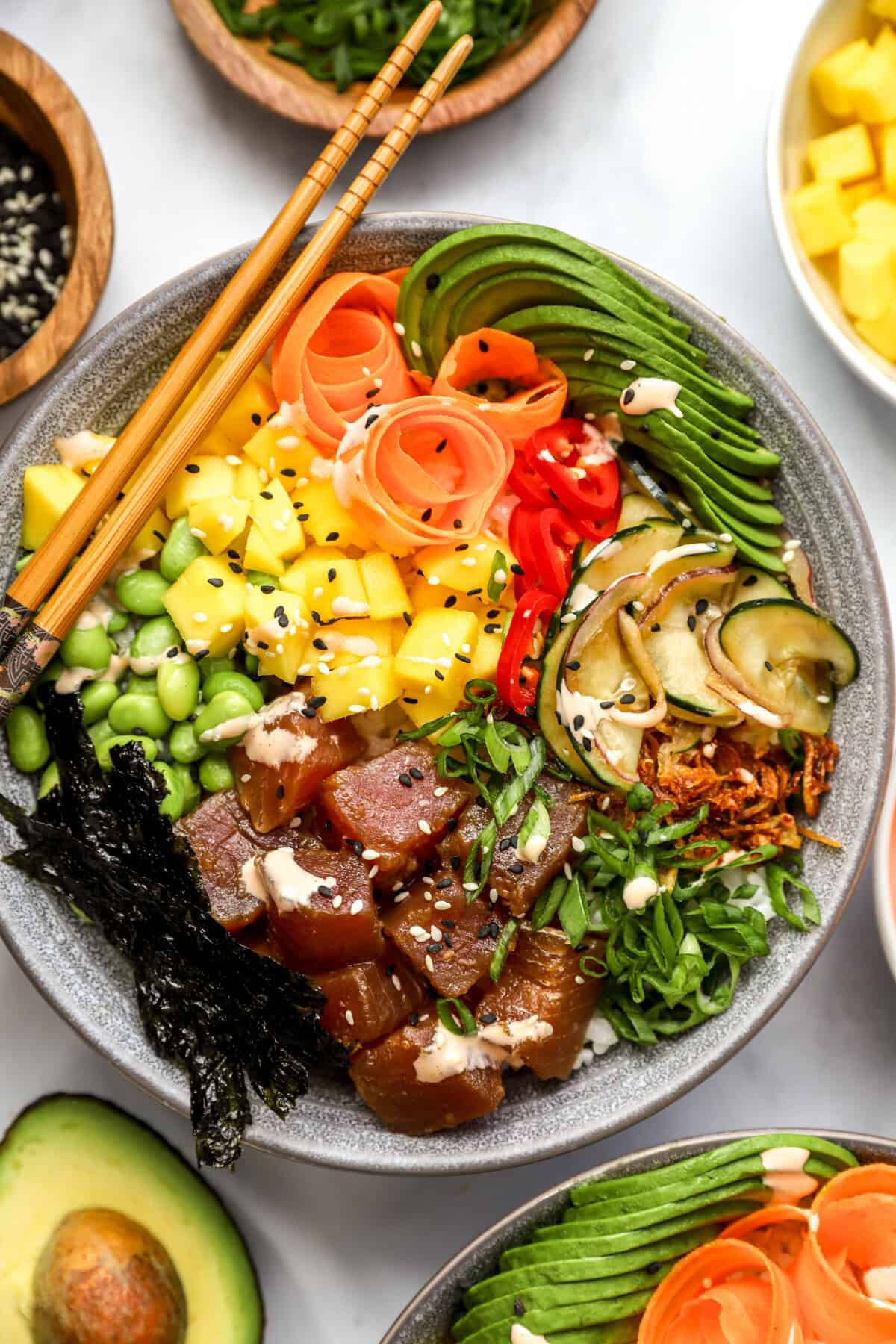 a finished poke bowl with chopsticks from above. 