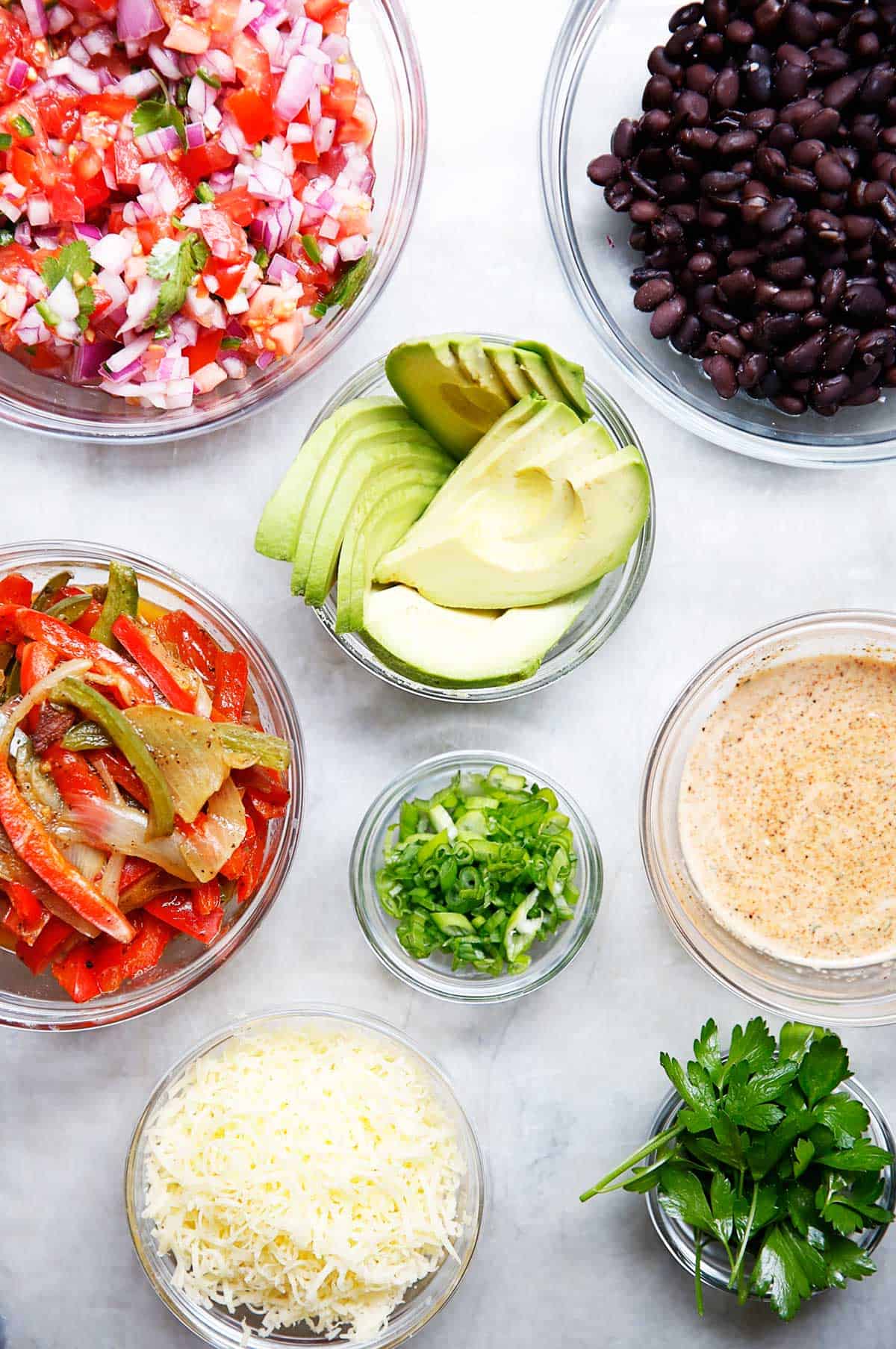burrito bowl ingredients in separate dishes.