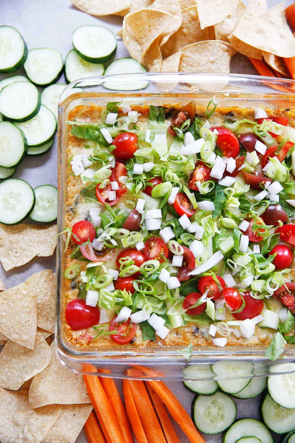 Southwest hummus with toppings in a baking dish