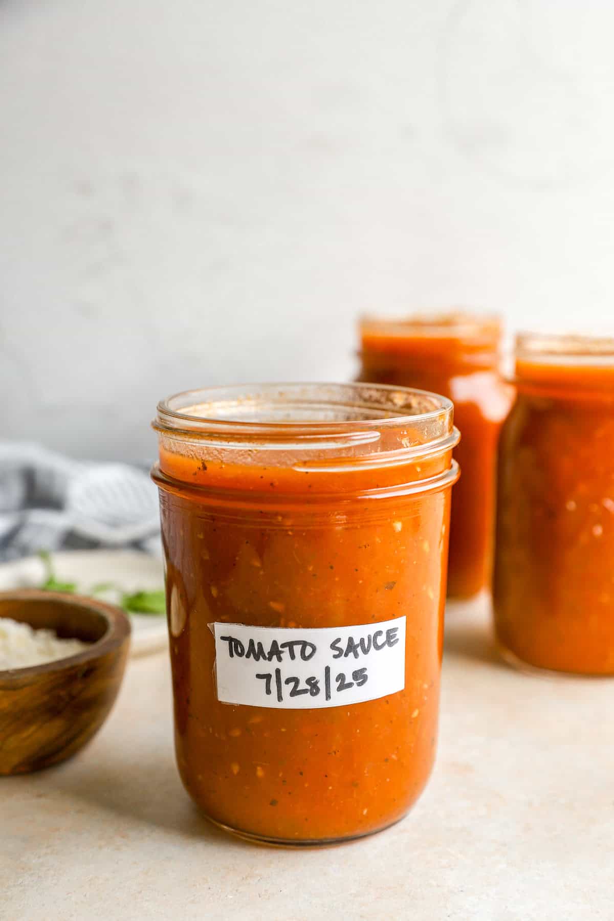 Tomato sauce stored in a smaller mason jar and labeled 