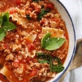 One-Pot Lasagna Soup made with gluten-free nooldles and garnished with basil