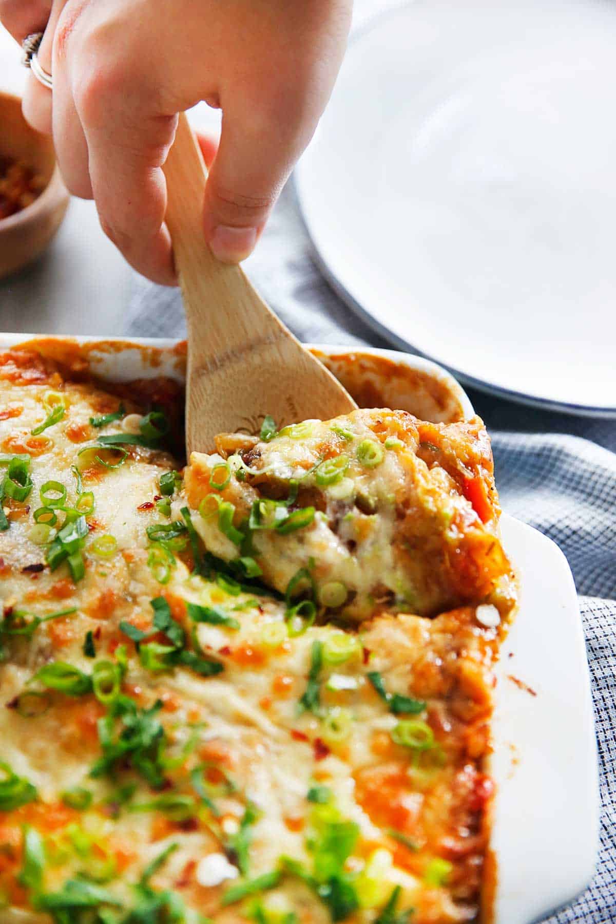 Scoop of enchilada casserole from the oven