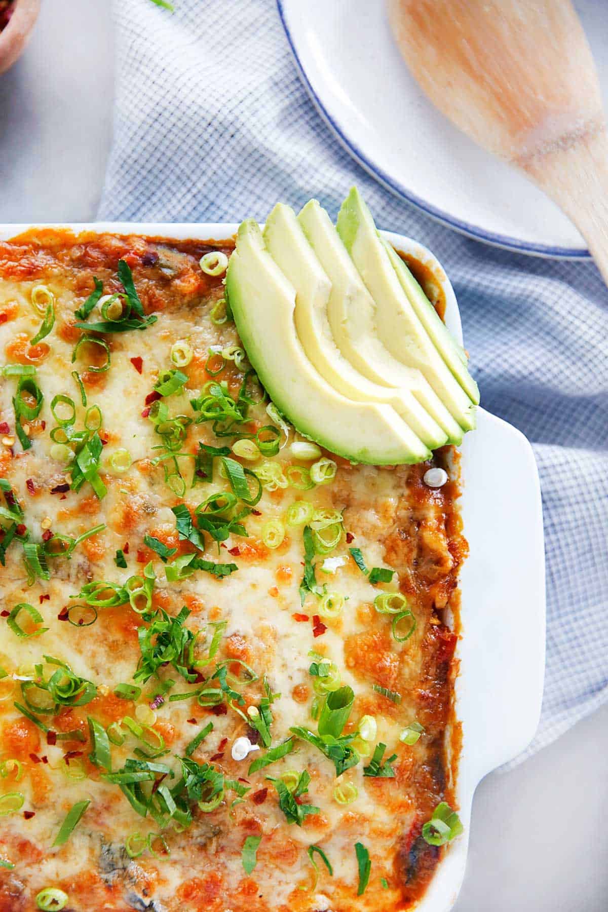 Cheesy top of casserole with avocado slices