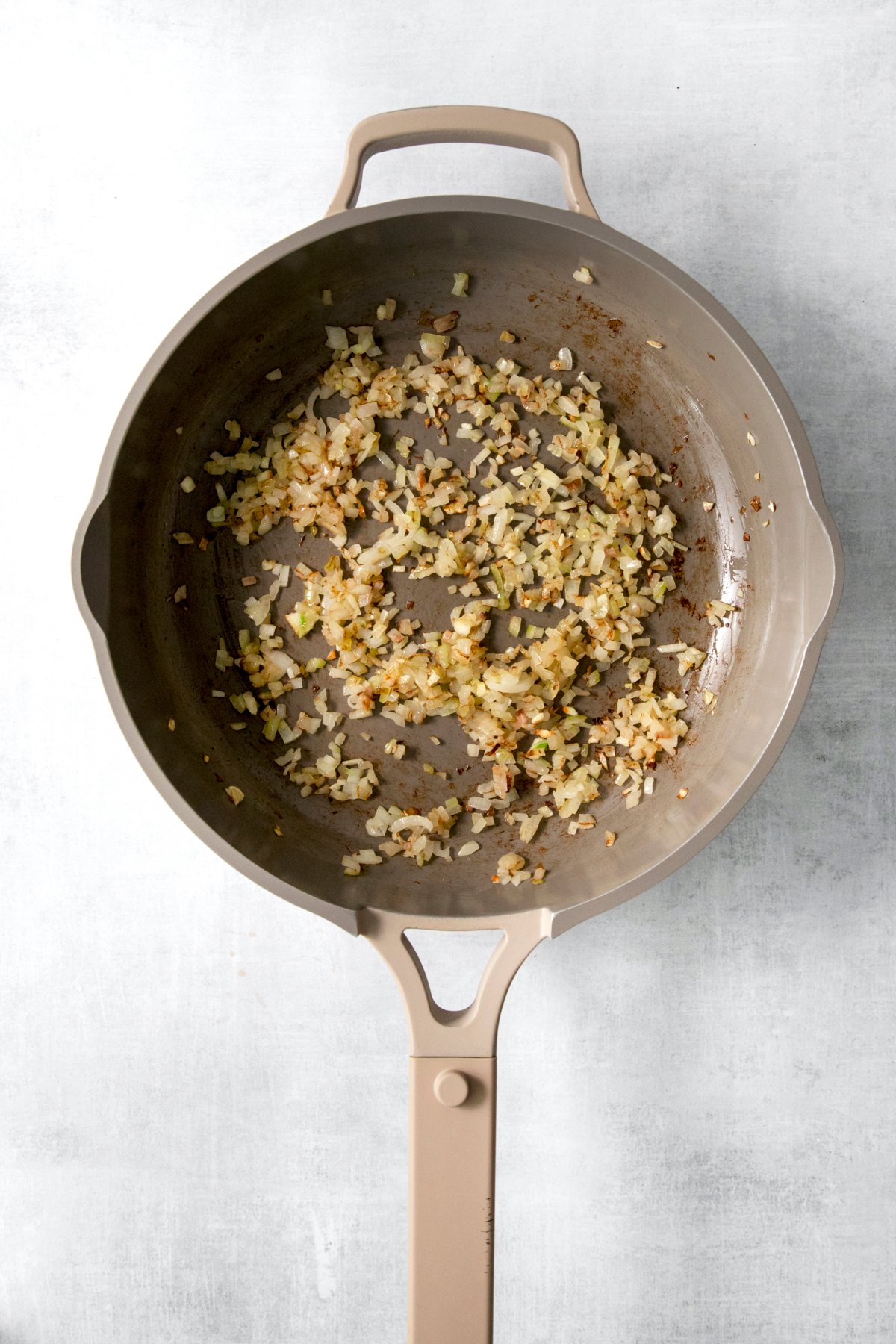 shallot, onion, and garlic cooked in a skillet.