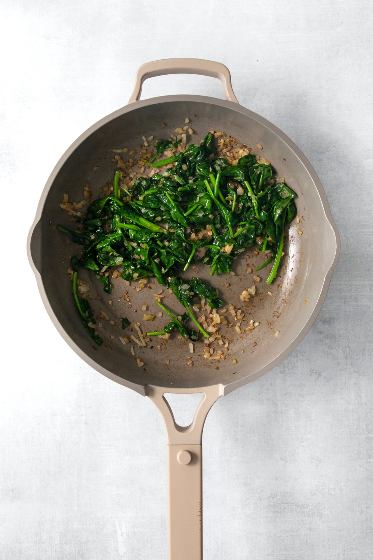 cooked spinach in a skillet.