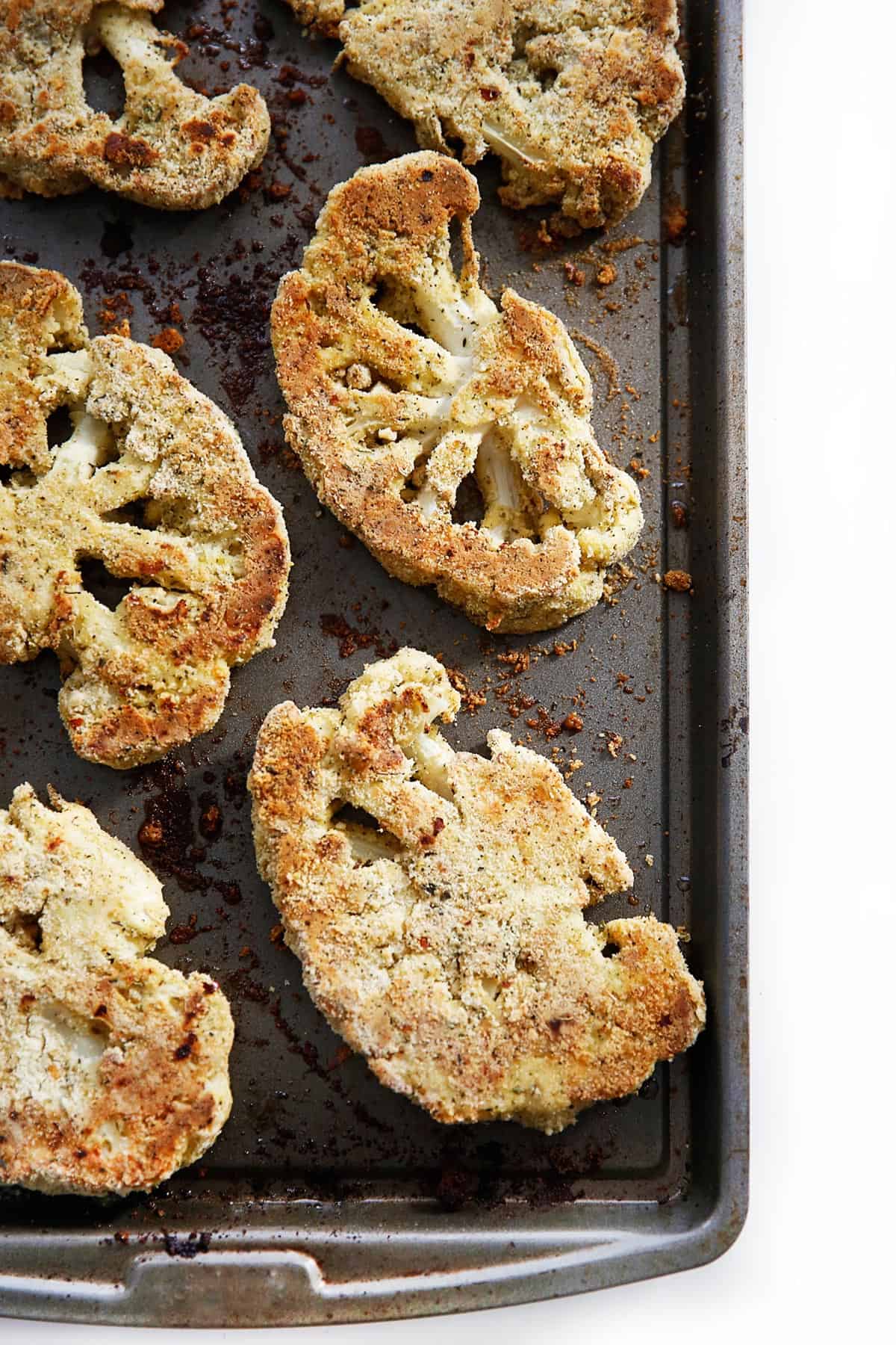 breaded cauliflower parmesan on a baking sheet.