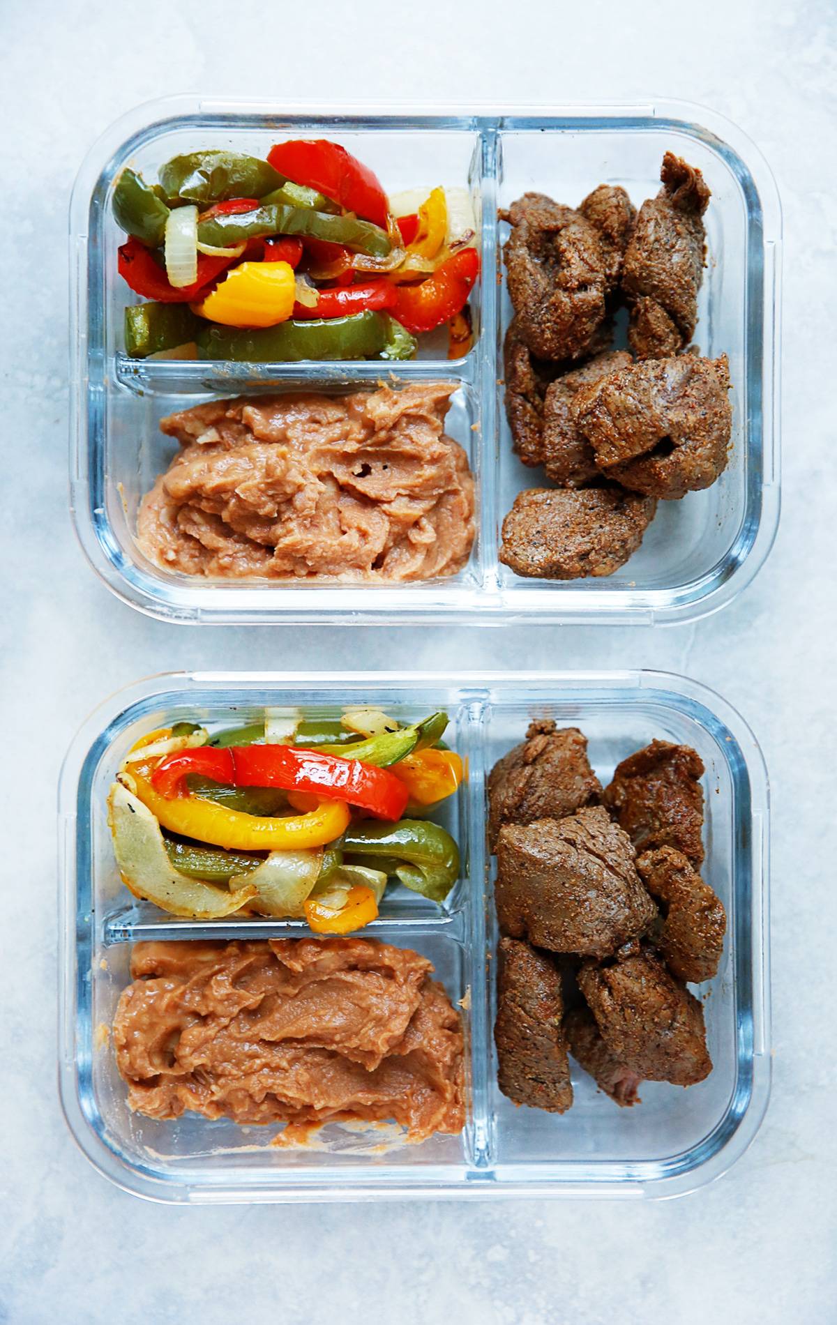 Sheet Pan Steak Fajitas stored in individual portioned containers.