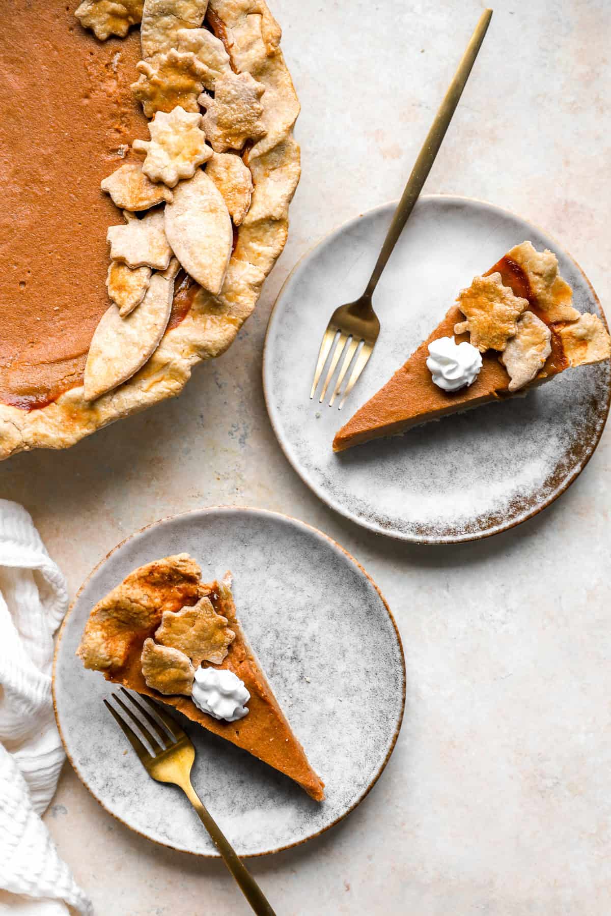 Gluten Free Pumpkin Pie sliced into two pieces and part of the full pie showing.