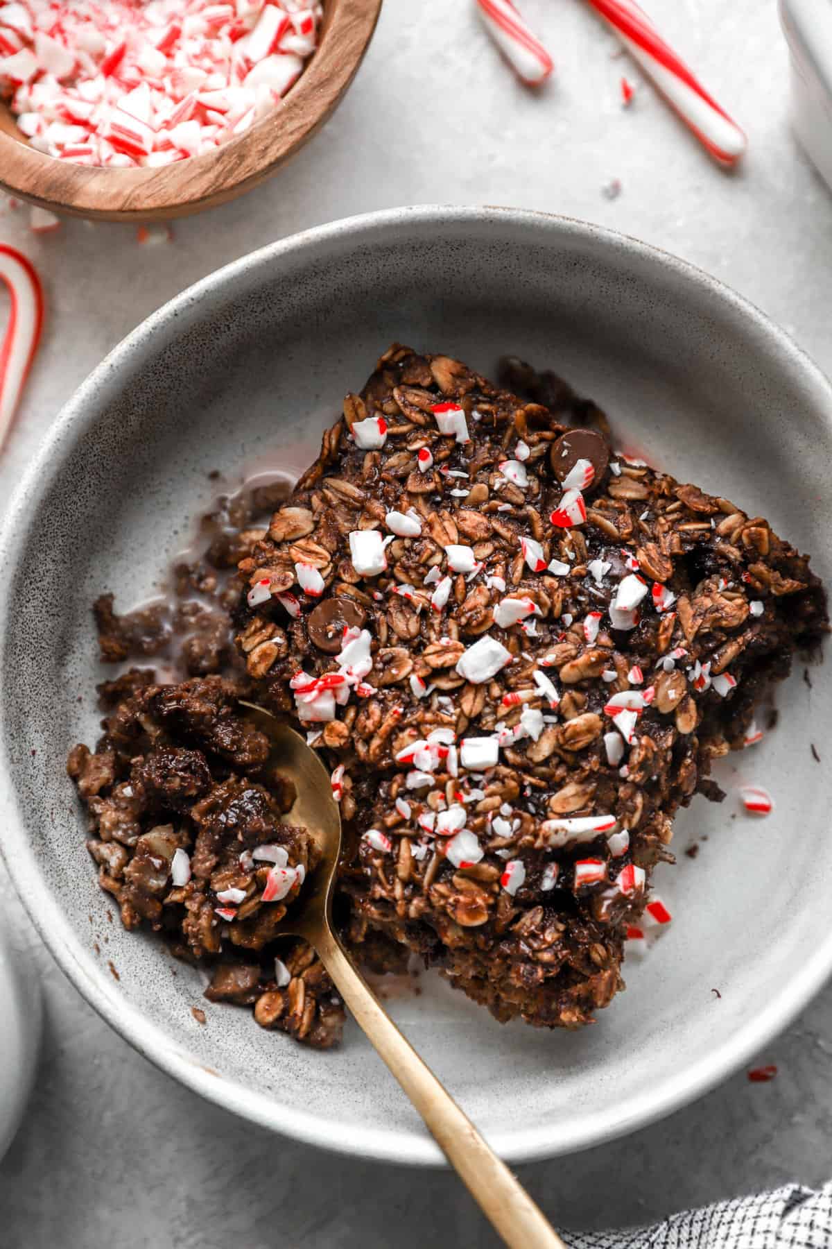 above image of a slice of chocolate peppermint baked oatmeal in a bowl with a spoon. 