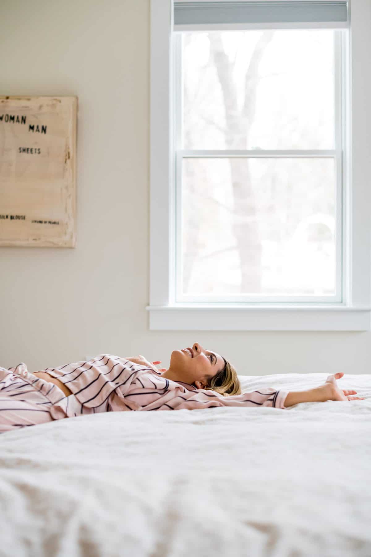 A happy woman in a bed