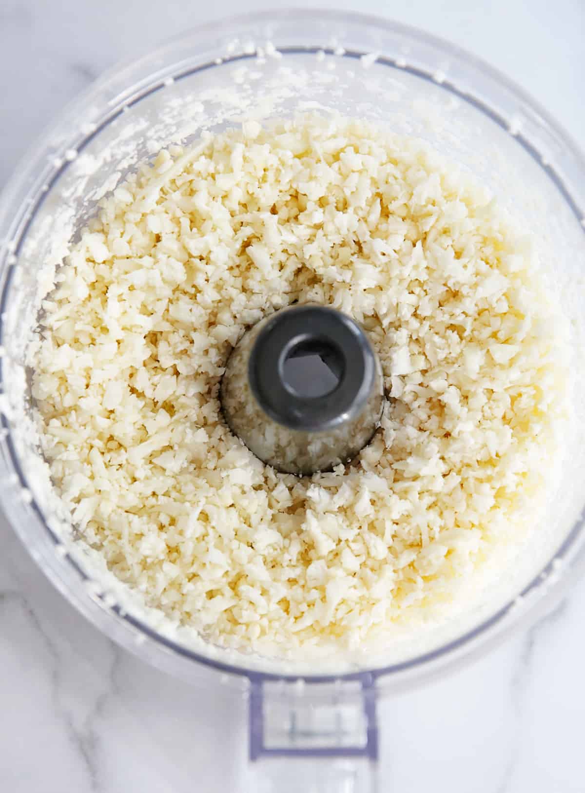 Homemade cauliflower rice in a food processor.