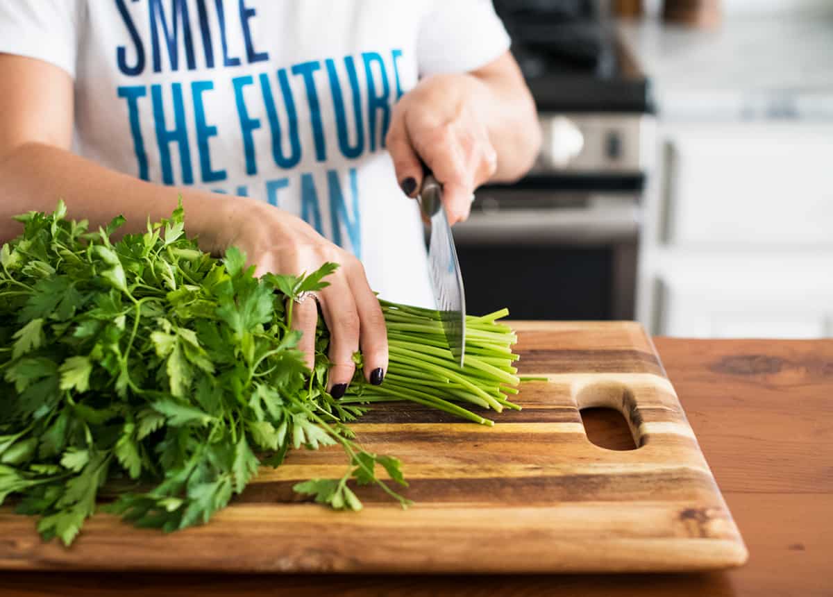 Cutting the ends off herbs so they last longer