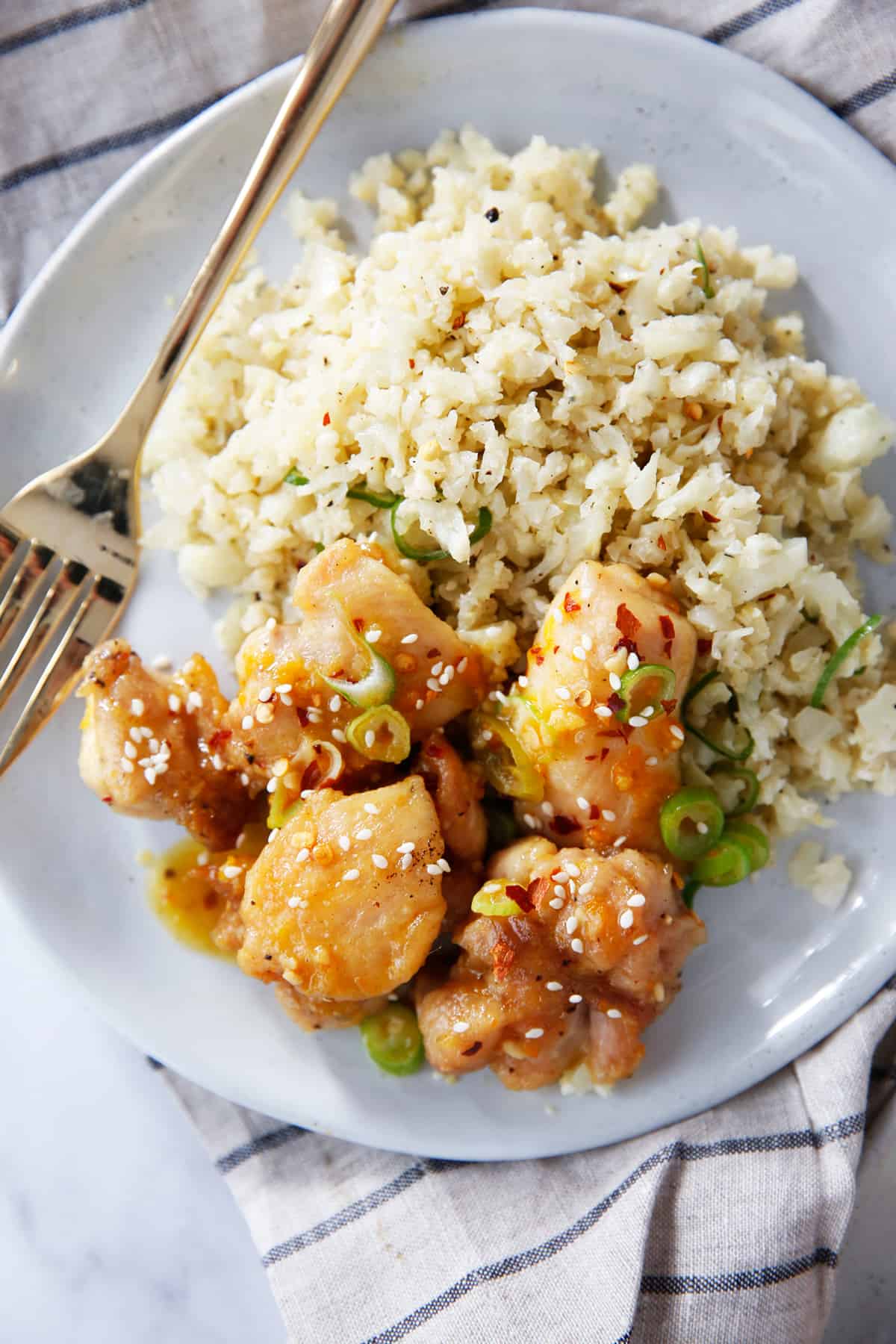 Paleo orange chicken with cauliflower rice on a plate