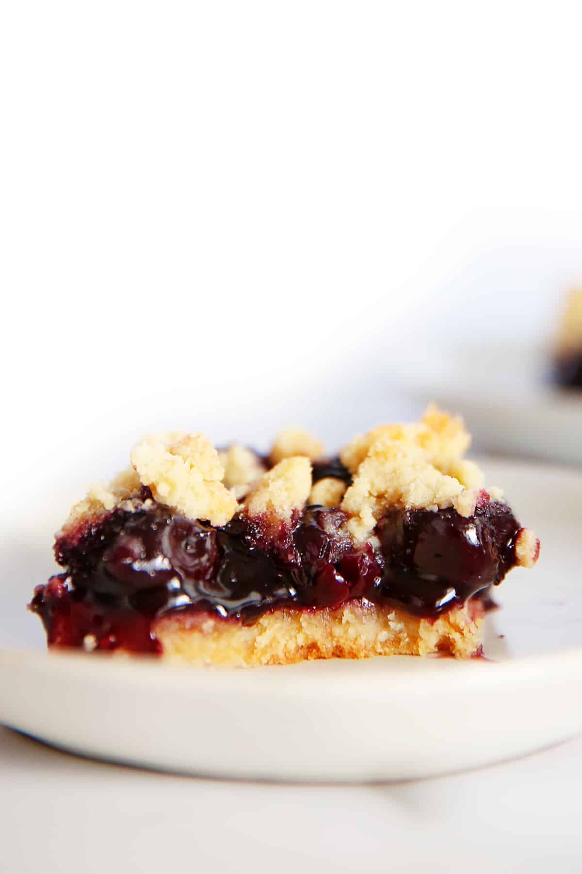 A slice of cherry pie bars on a plate.