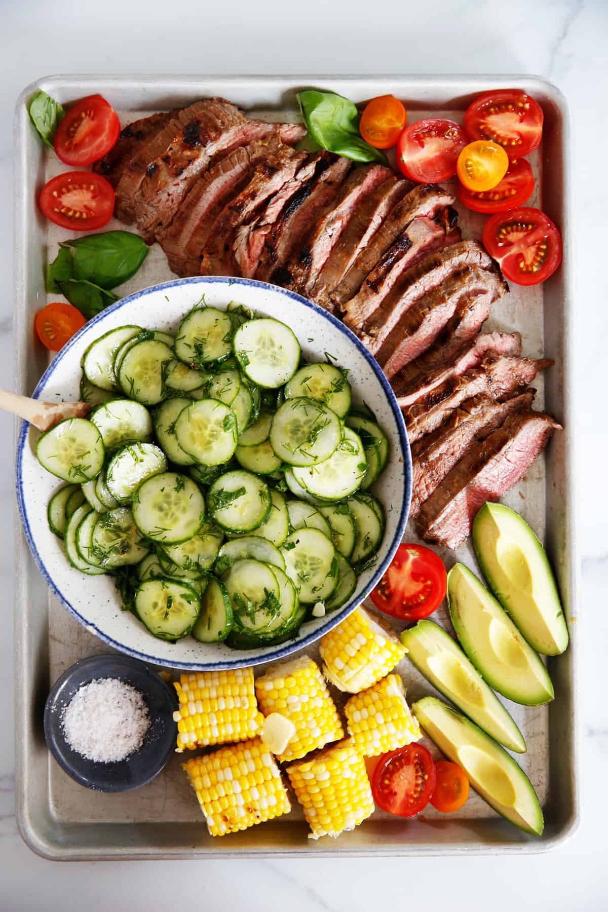 grilled flank steak with sides to serve