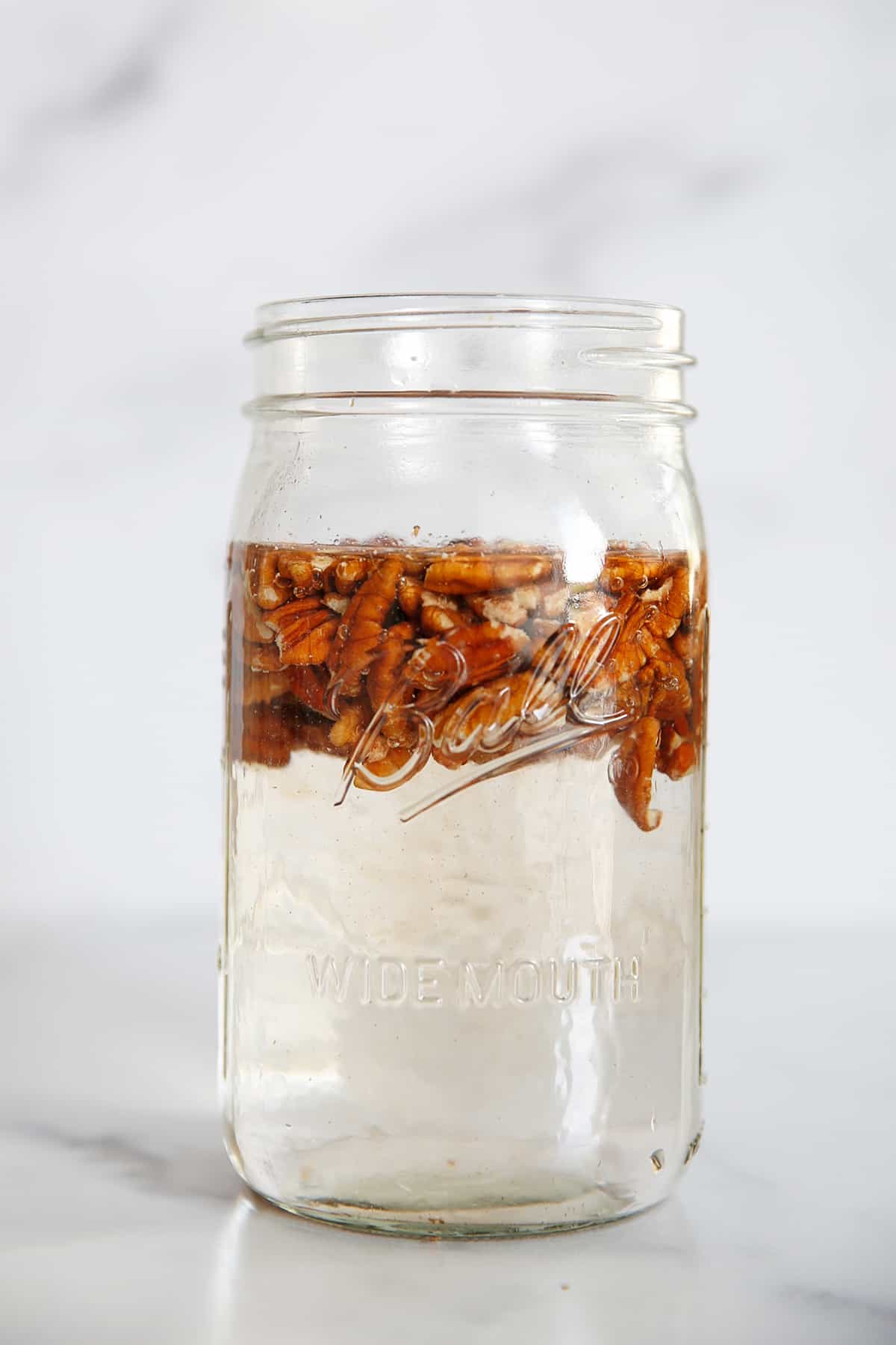 pecans soaking in a jar