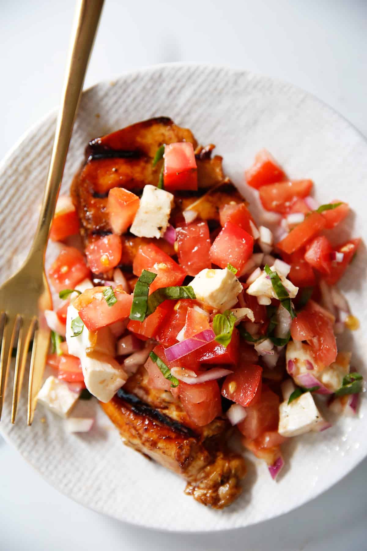 Bruschetta chicken on a plate.